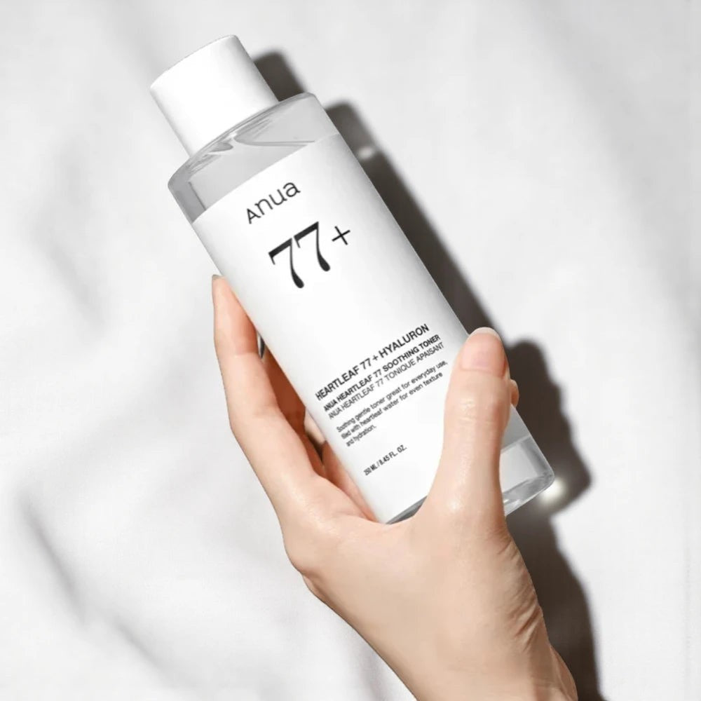 Skin TOGO Anua Heartleaf 77 Soothing Toner bottle held in hand, featuring a clear liquid formula for sensitive skin.