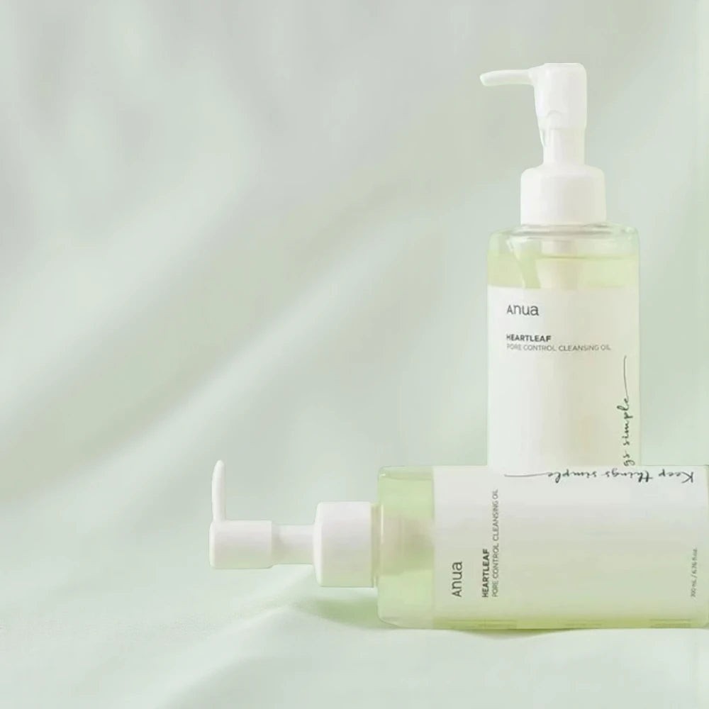Skin TOGO Anua Heartleaf Pore Control Cleansing Oil bottles on a soft green background for deep pore cleansing.