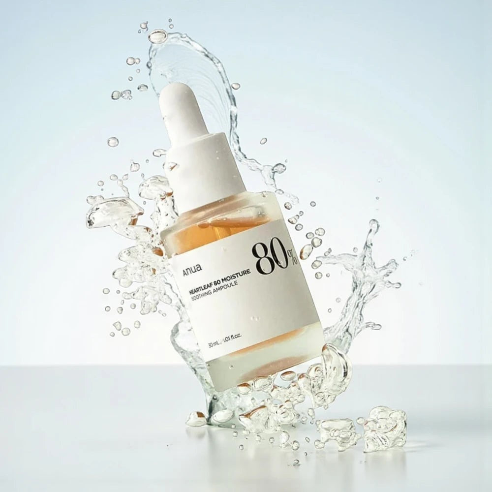 Skin TOGO Anua Heartleaf 80% Soothing Ampoule in a 30ml glass dropper bottle surrounded by a refreshing water splash.