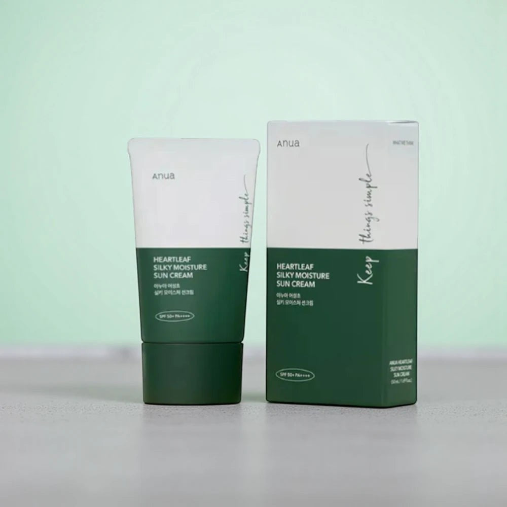 Skin TOGO Anua Heartleaf Silky Moisture Sun Cream tube and box with SPF50+ protection on a soft green background.