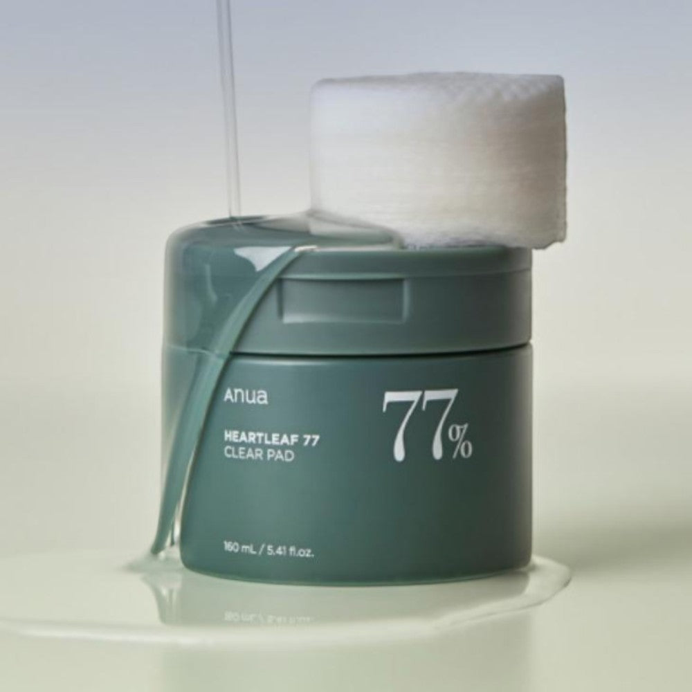Skin TOGO ANUA Heartleaf 77% Clear Pad toner pads in a green jar with a single pad on top and liquid dripping down