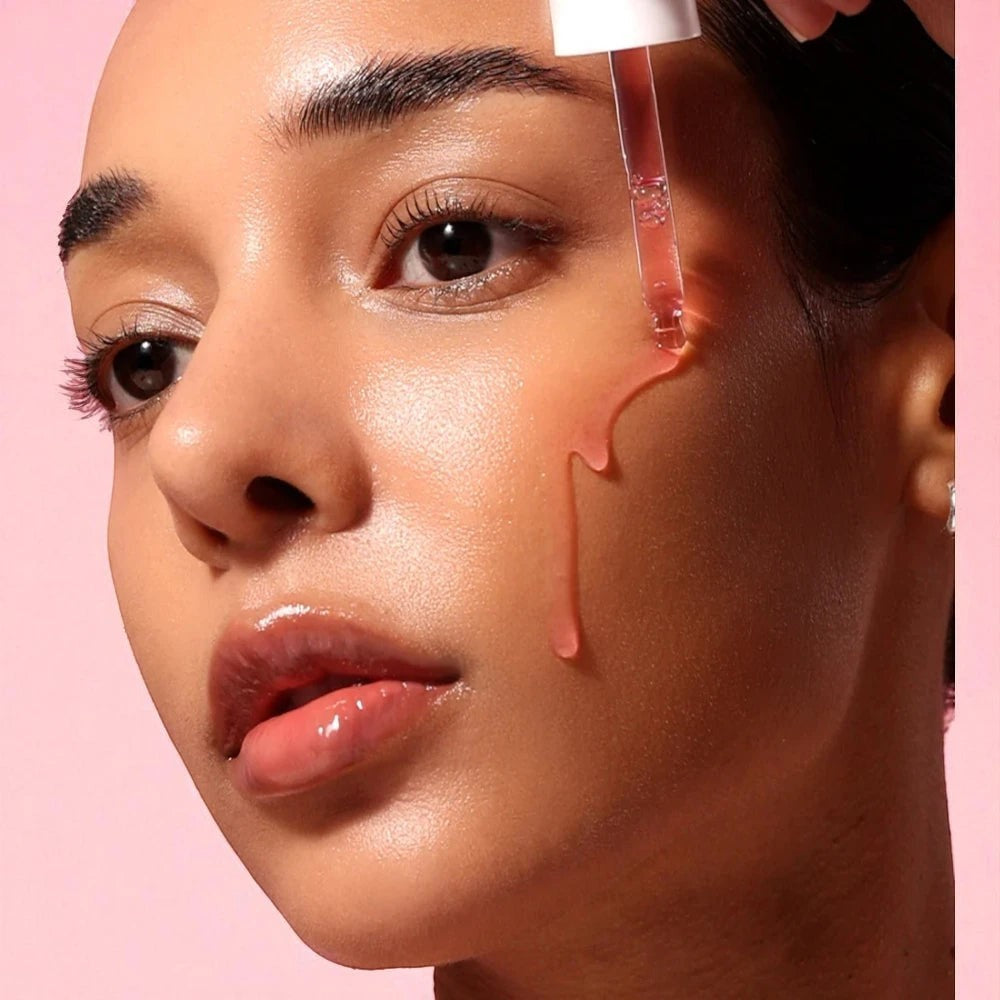 Skin TOGO Anua Niacinamide 10% and TXA 4% serum being applied to a model's glowing, hydrated skin.