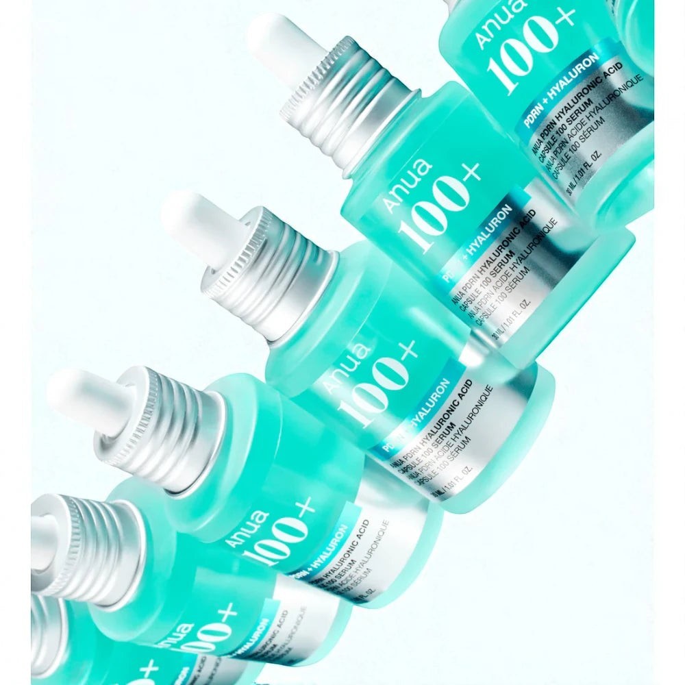 Skin TOGO Anua PDRN Hyaluronic Acid Capsule 100 Serum bottles in a diagonal row against a light blue background.
