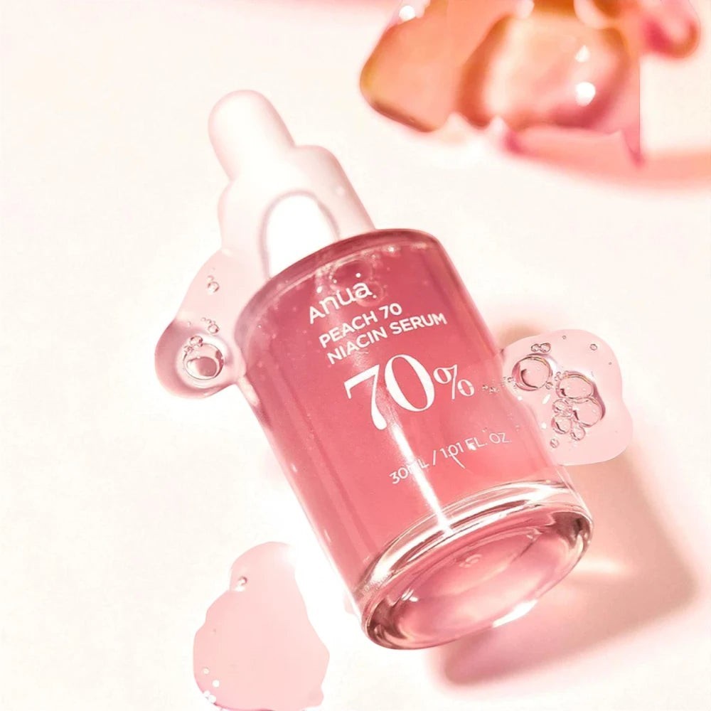 Skin TOGO Anua Peach 70% Niacin Serum in a glass dropper bottle with pink serum texture on a light background
