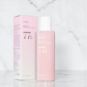 Skin TOGO Anua Peach 77 Niacin Conditioning Milk Toner bottle and box in soft pink packaging on marble surface