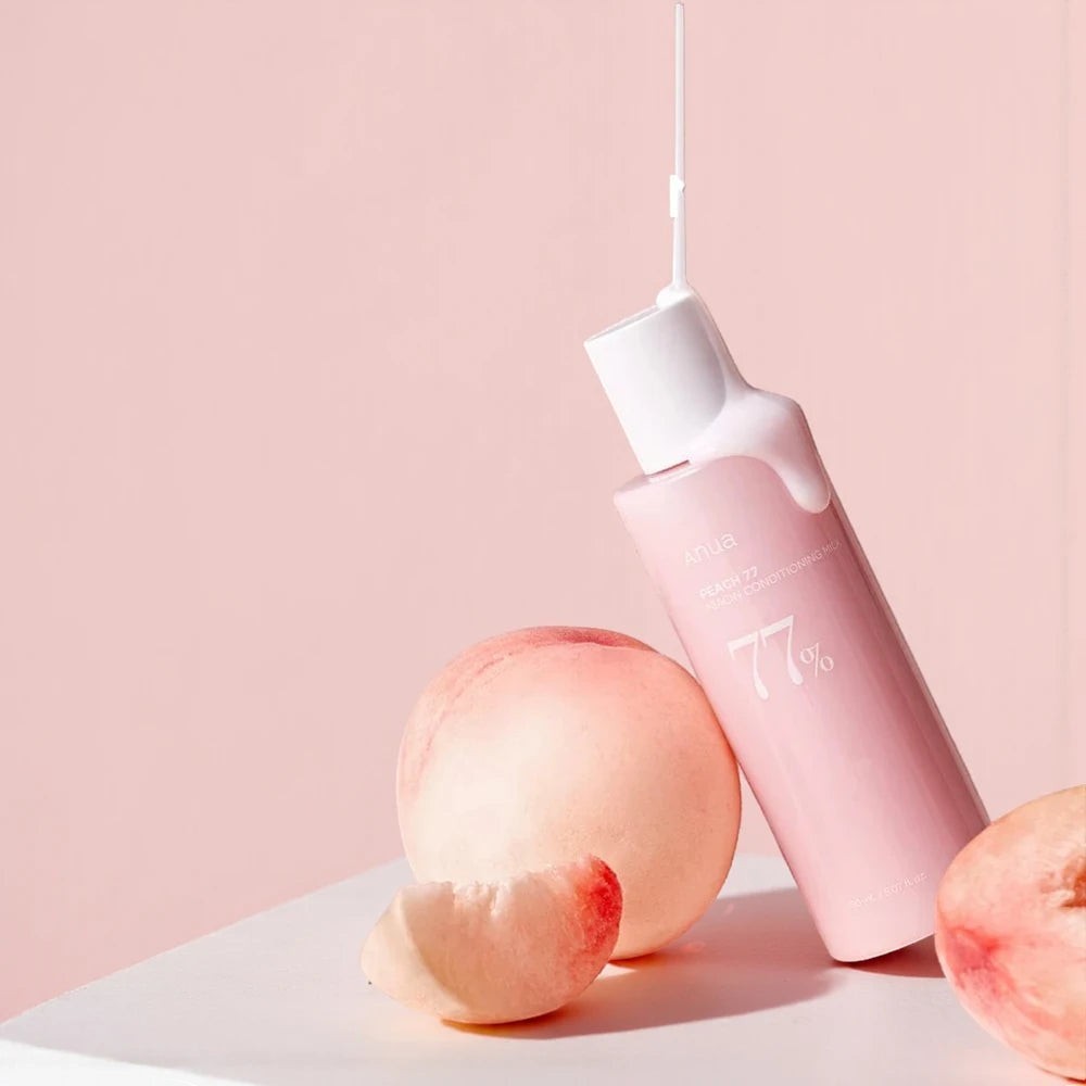 Skin TOGO Anua Peach 77 Niacin Conditioning Milk Toner bottle with creamy texture dripping, surrounded by fresh peaches