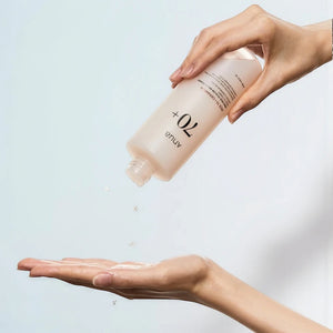 Skin TOGO Anua Rice 70 Glow Milky Toner being poured from a 250ml bottle into a hand for skincare application