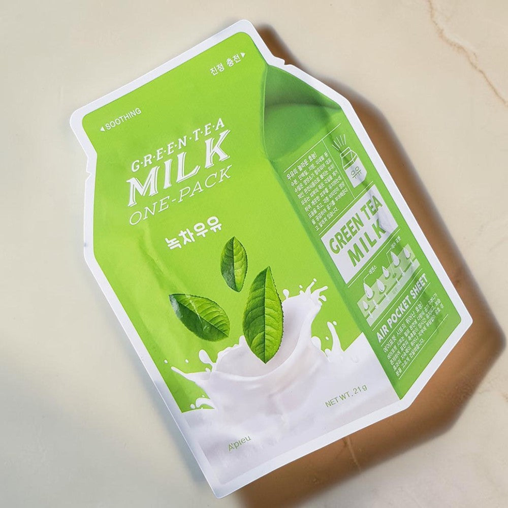 Skin TOGO A'PIEU Milk One Pack Green Tea sheet mask in a light green milk carton shaped pouch with tea leaf graphics.