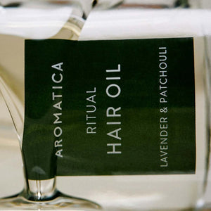 Skin TOGO Aromatica Ritual Hair Oil with lavender and patchouli in a 50ml glass bottle for nourishing hair care.