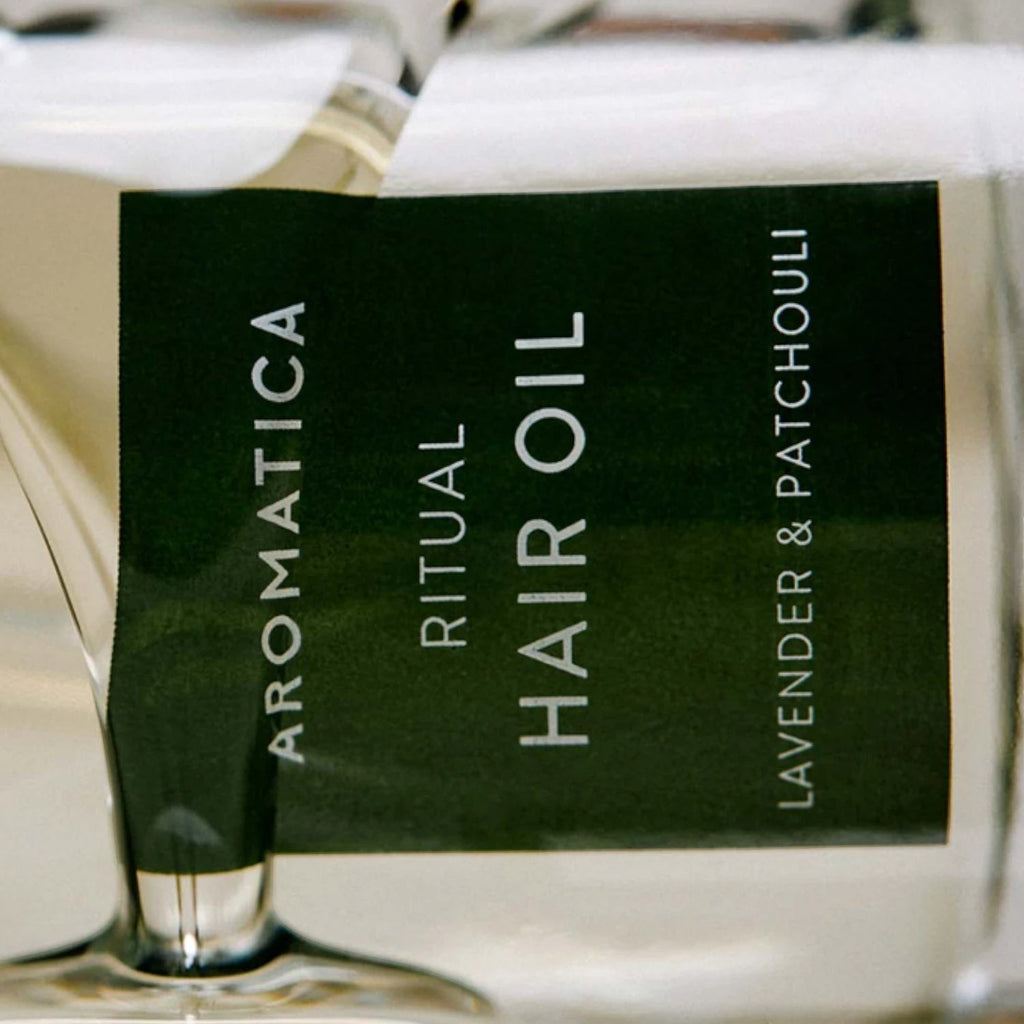 Skin TOGO Aromatica Ritual Hair Oil with lavender and patchouli in a 50ml glass bottle for nourishing hair care.
