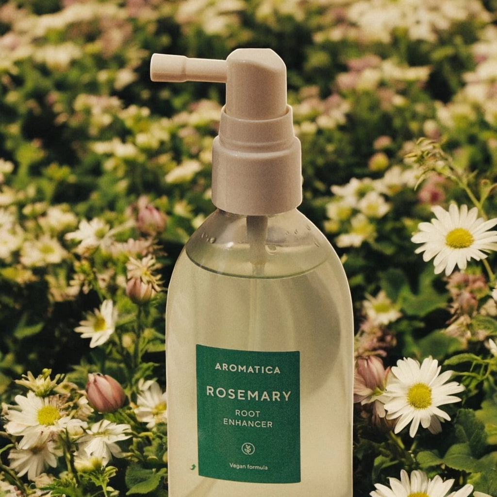 Skin TOGO Aromatica Rosemary Root Enhancer spray bottle in a field of white daisies for hair growth and scalp care.