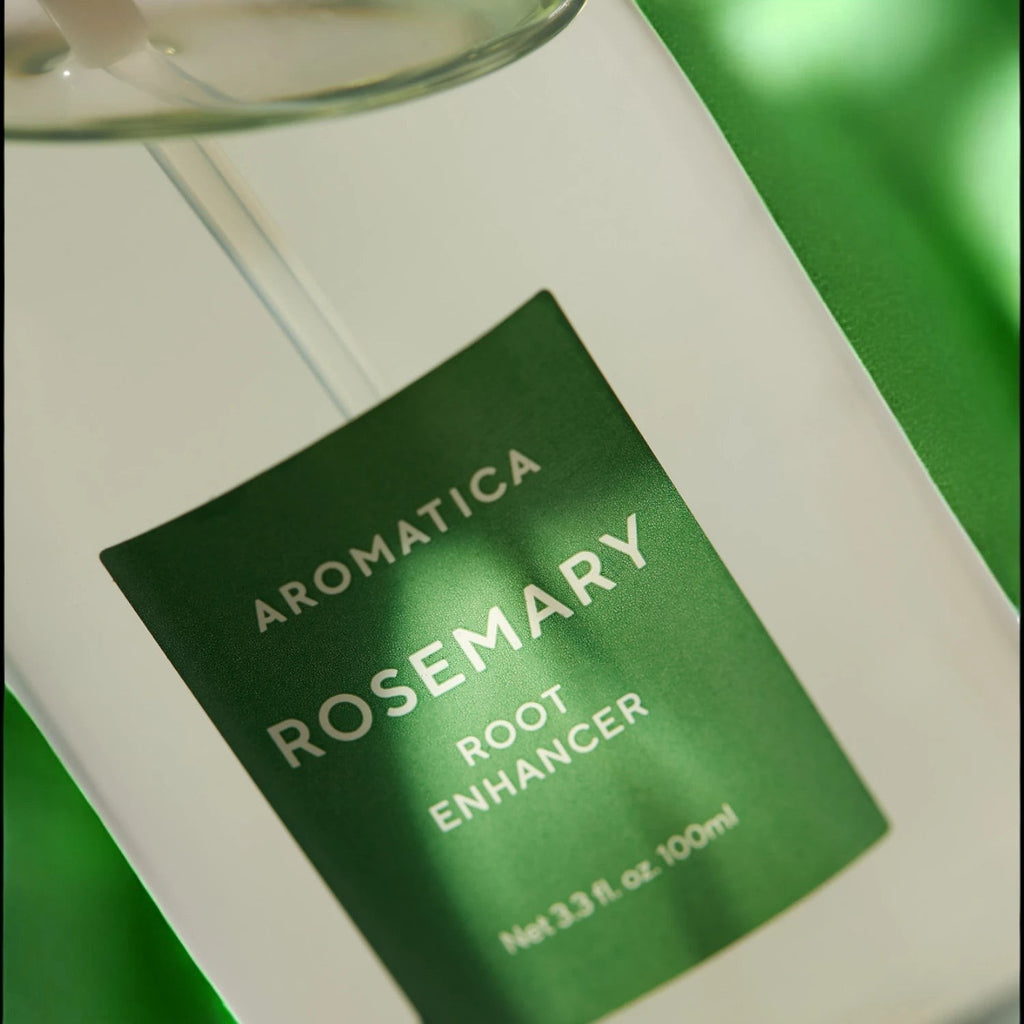 Skin TOGO Aromatica Rosemary Root Enhancer 100ml hair serum bottle with green label against a soft green background.