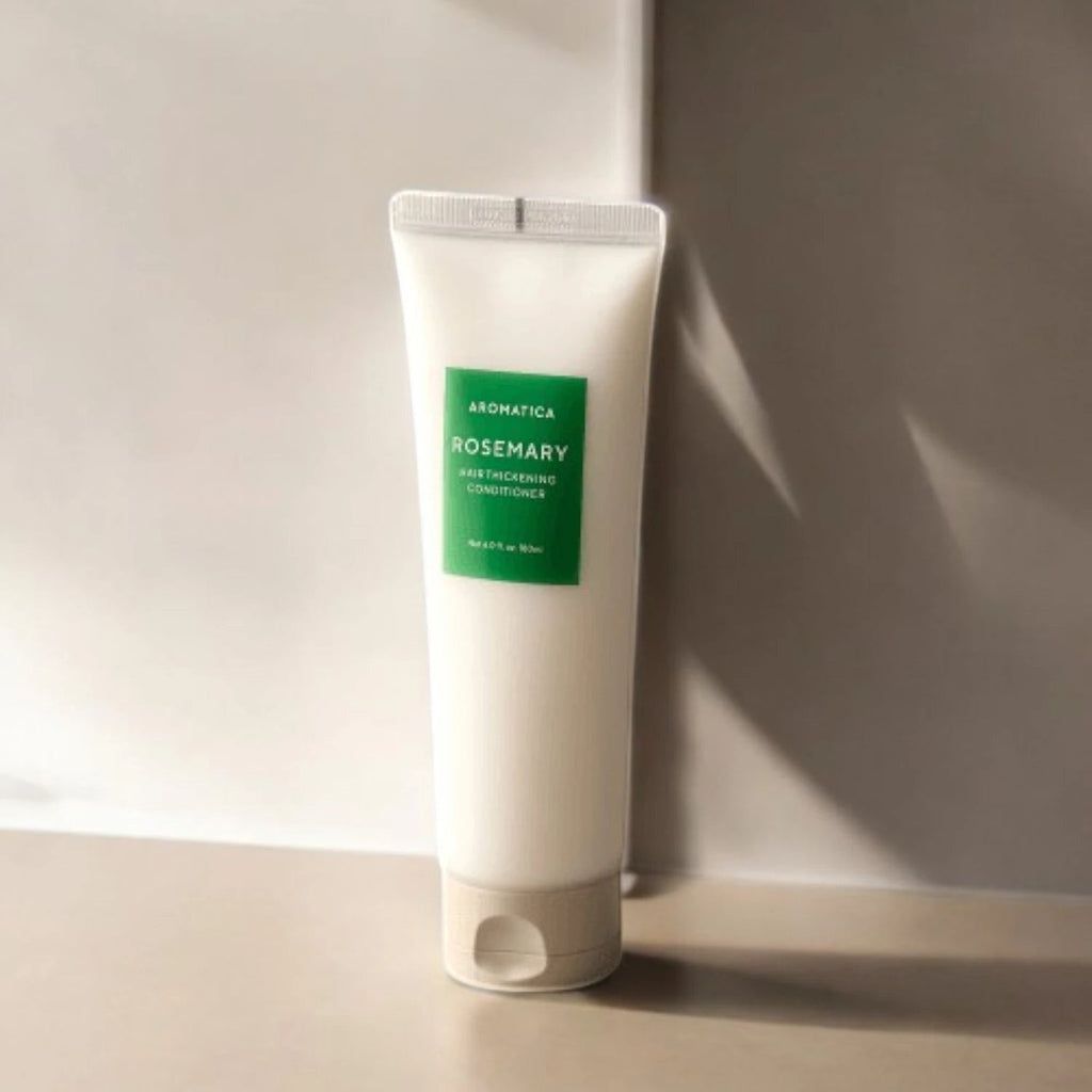 Skin TOGO Aromatica Rosemary Scalp Scaling shampoo in a white squeeze tube with a green label on a neutral surface.