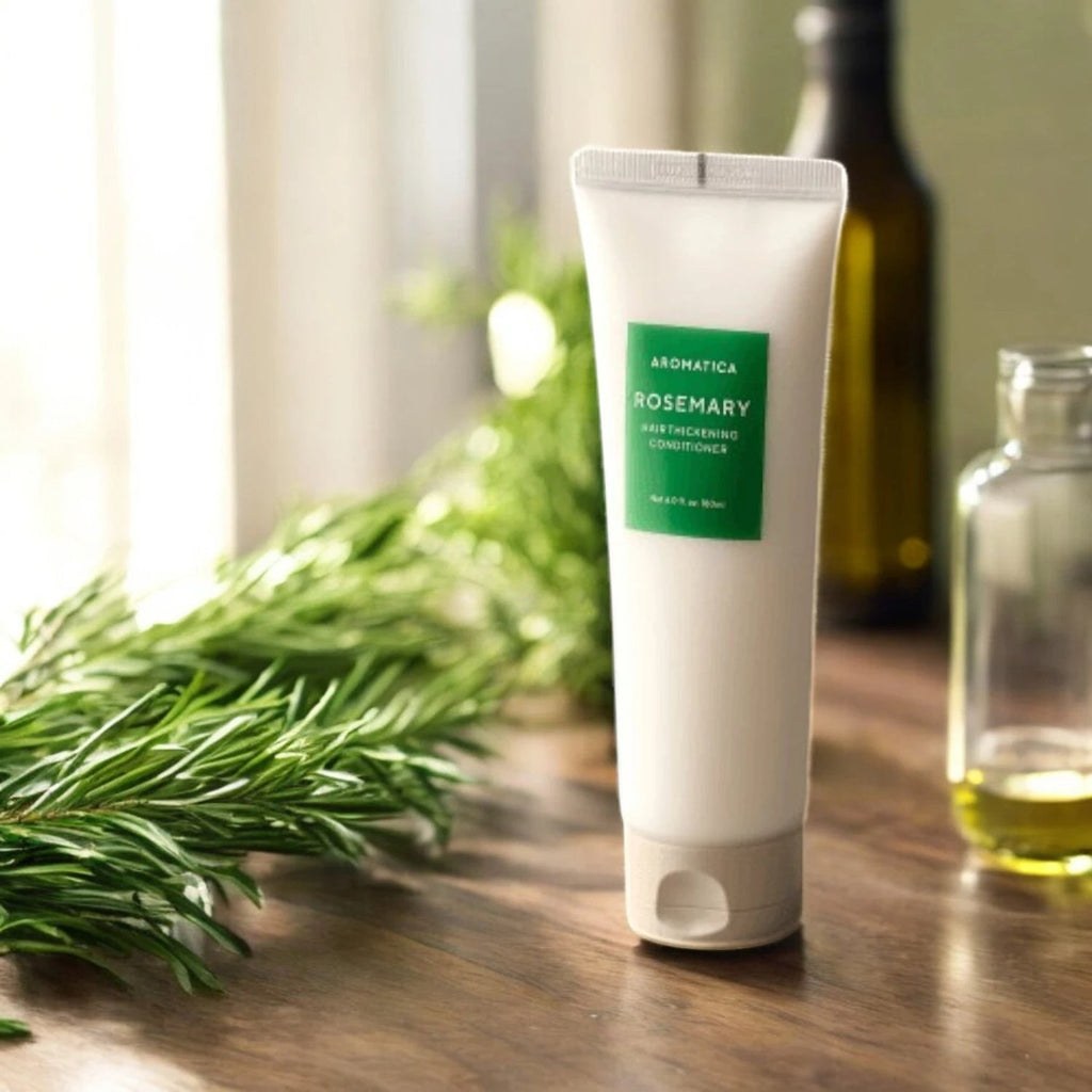 Skin TOGO Aromatica Rosemary Scalp Scaling shampoo in a white tube with green label on a wooden table with rosemary