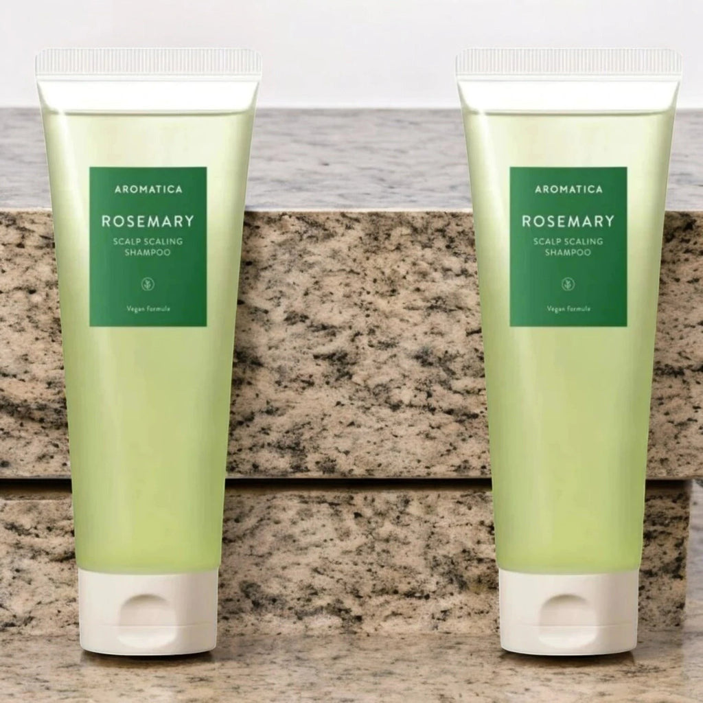 Skin TOGO Aromatica Rosemary Scalp Scaling Shampoo in two translucent green tubes on a stone surface.