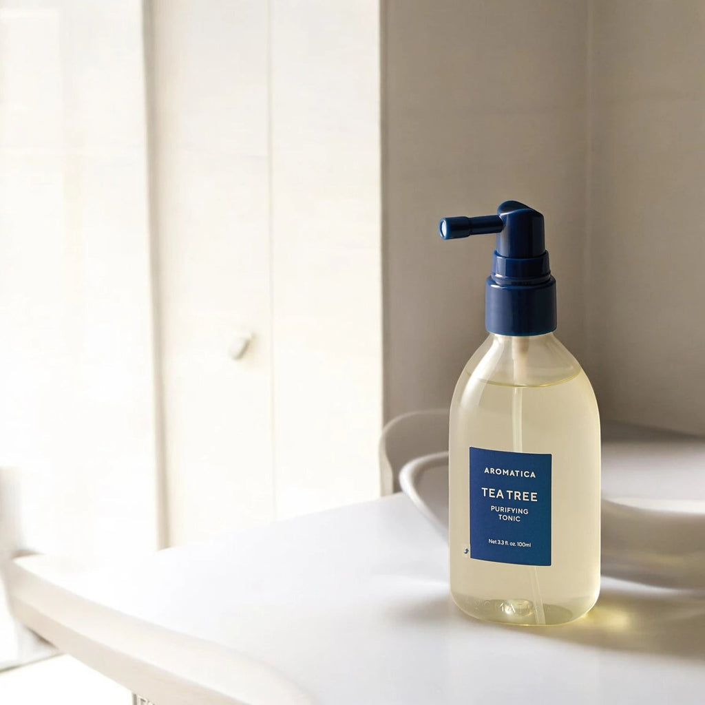 Skin TOGO Aromatica Tea Tree Purifying Tonic in a clear 100ml spray bottle for oily scalp care on a white surface.