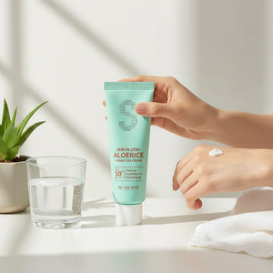 Skin TOGO Be The Skin Sebum Zero Aloerice vegan sun cream in a mint green tube held by a hand with cream swatch