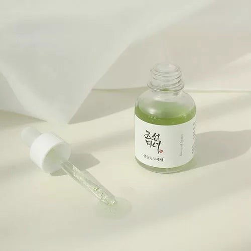 Skin TOGO Beauty of Joseon Calming Serum with green tea and panthenol in a 30ml glass dropper bottle on soft fabric.