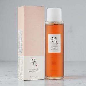 Skin TOGO Beauty of Joseon Ginseng Essence Water in a clear bottle with a pale pink box on a white surface.