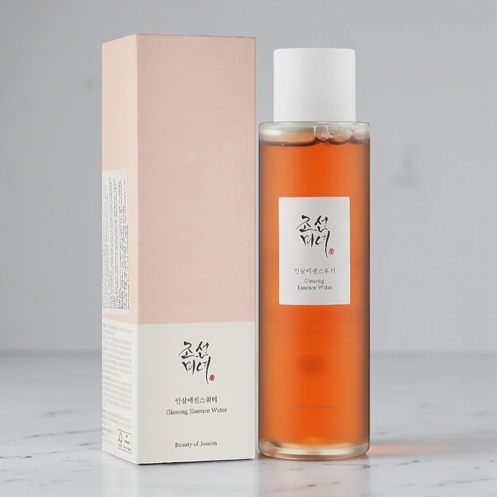 Skin TOGO Beauty of Joseon Ginseng Essence Water in a clear bottle with a pale pink box on a white surface.
