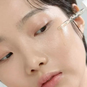 Skin TOGO Beauty of Joseon Glow Deep Serum being applied with a dropper to a model's glowing, clear skin.