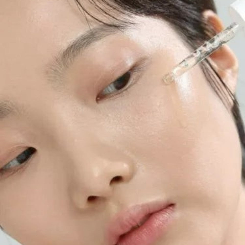 Skin TOGO Beauty of Joseon Glow Deep Serum being applied with a dropper to a model's glowing, clear skin.
