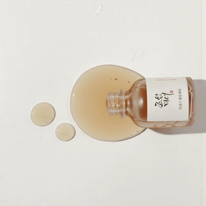 Skin TOGO Beauty of Joseon Revive Serum with ginseng and snail mucin, showing the amber liquid texture on white.