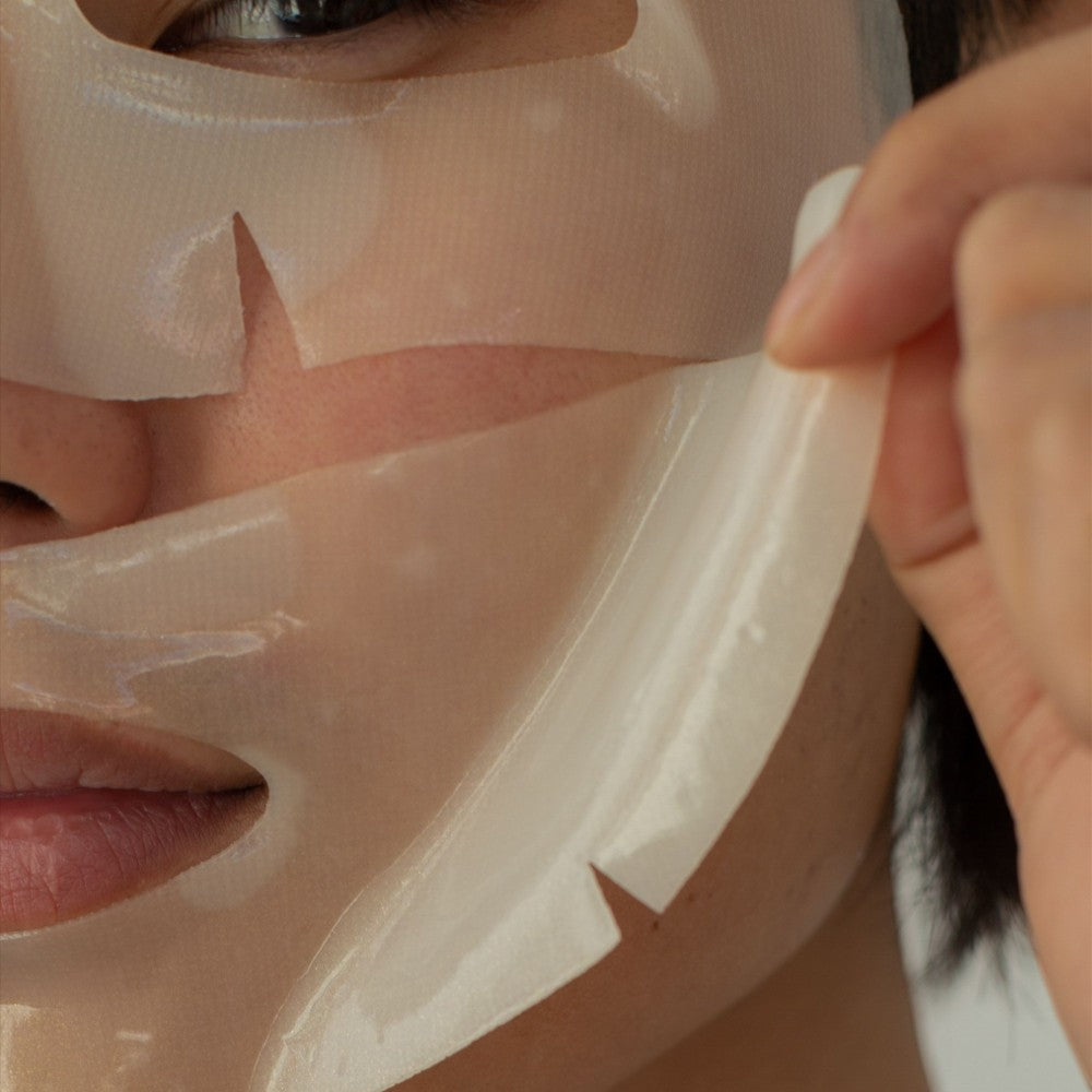 Skin TOGO Seoul Girl's Beauty Secret brightening sheet mask being applied to a person's face for radiant skin.