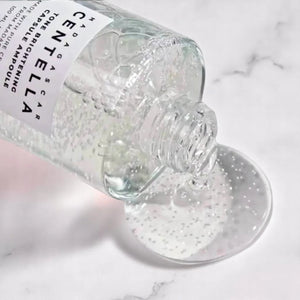 Skin TOGO Centella Tone Capsule Ampoule with visible brightening capsules pouring onto a white marble surface.