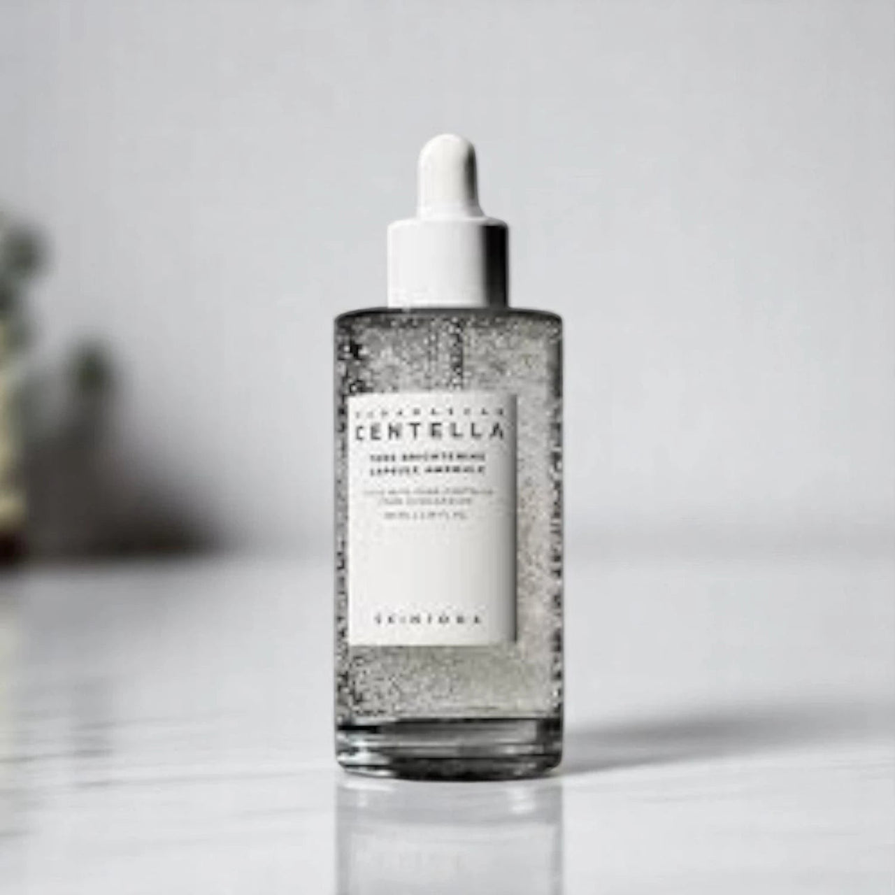 Skin TOGO Centella Tone Capsule Ampoule in a clear glass dropper bottle with visible brightening capsules.