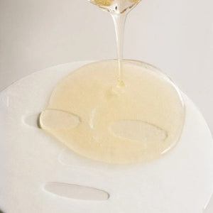 Skin TOGO Madagascar Centella Watergel Sheet Mask being saturated with a soothing, clear hydrating ampoule essence.