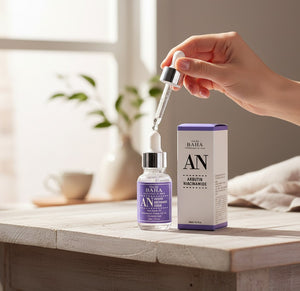 Skin TOGO Cos De BAHA AN Arbutin Niacinamide serum bottle with dropper and packaging on a wooden table.