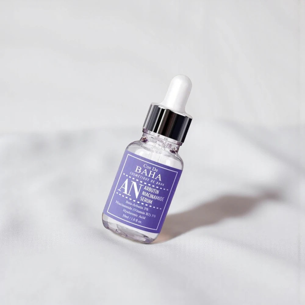 Skin TOGO Cos De BAHA AN Arbutin Niacinamide brightening serum in a 30ml glass dropper bottle on a white background.
