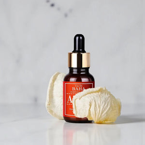 Skin TOGO Cos De BAHA AZ Azelaic Acid 10 serum in a brown glass dropper bottle with dried flower petals