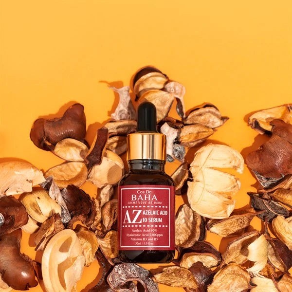 Skin TOGO Cos De BAHA AZ Azelaic Acid 10 serum in a dark glass bottle surrounded by dried botanical elements.