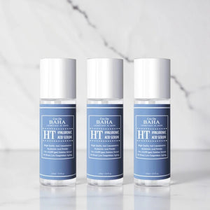 Three bottles of Skin TOGO Cos De BAHA Hyaluronic Acid Serum with blue labels on a white marble surface.