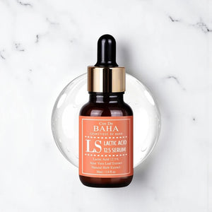 Skin TOGO Cos De BAHA LS Lactic Acid 12.5% exfoliating serum in a brown glass dropper bottle on a marble surface.
