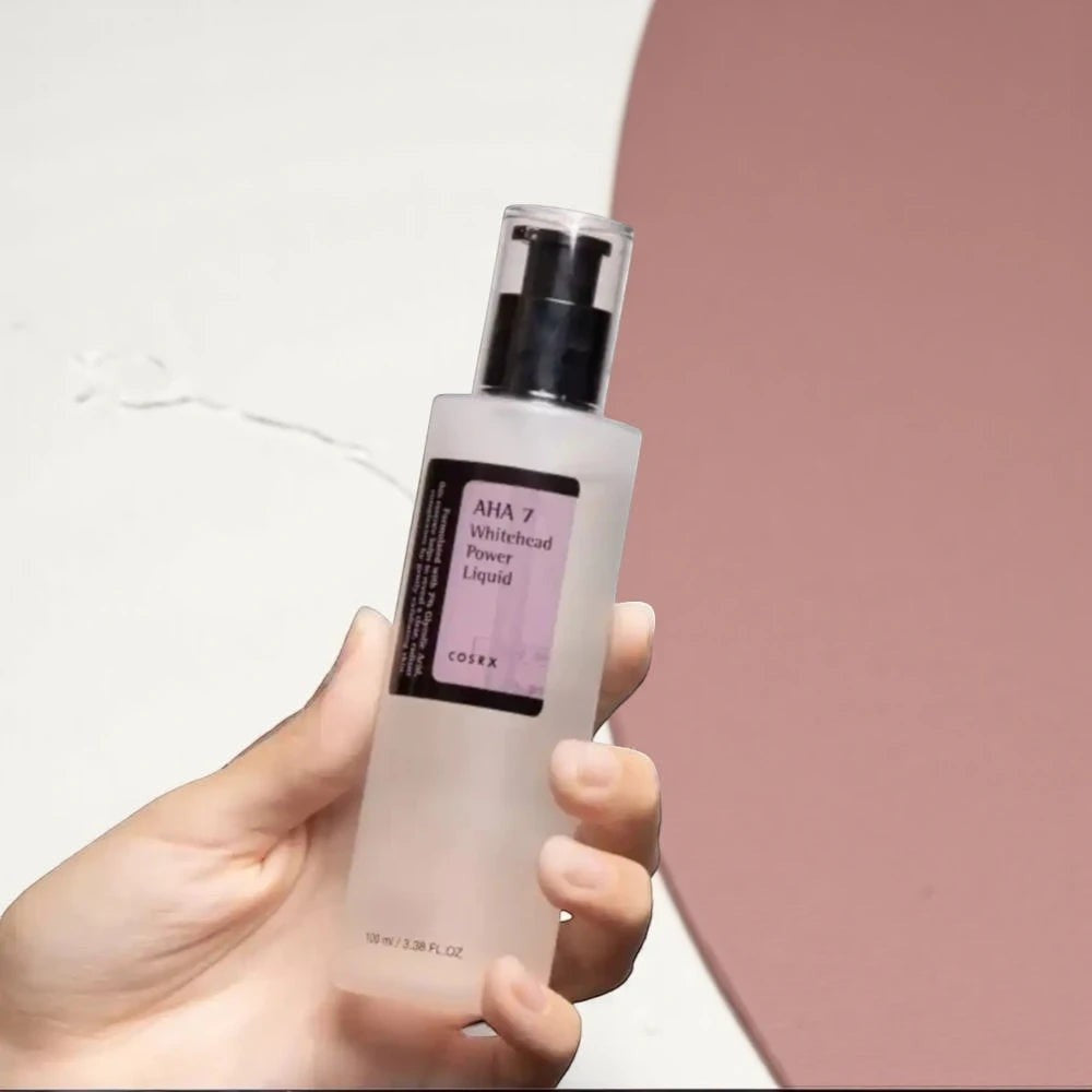 Skin TOGO Cosrx AHA 7 Whitehead Power Liquid chemical exfoliant in a clear 100ml pump bottle held in a hand.