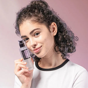 Skin TOGO model holding a bottle of Cosrx AHA 7 Whitehead Power Liquid chemical exfoliant for smooth skin