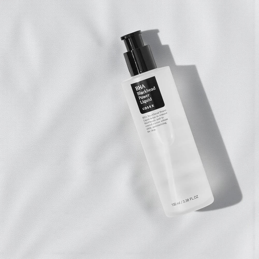 Skin TOGO Cosrx BHA Blackhead Power Liquid exfoliating serum bottle on a soft white fabric background