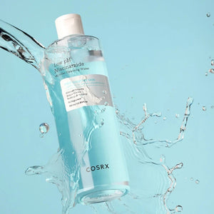 Skin TOGO COSRX Low pH Niacinamide Micellar Cleansing Water bottle surrounded by refreshing water splashes