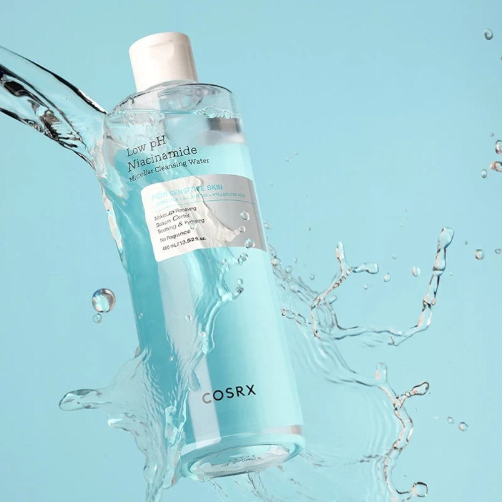 Skin TOGO COSRX Low pH Niacinamide Micellar Cleansing Water bottle surrounded by refreshing water splashes