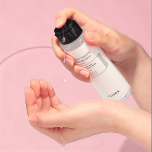 Skin TOGO COSRX The 6 Peptide Skin Booster serum being dispensed from a clear bottle into hands for skincare routine.