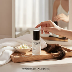 Skin TOGO COSRX Peptide-132 hair bonding oil serum bottle on a wooden tray with a white towel and jasmine flowers.