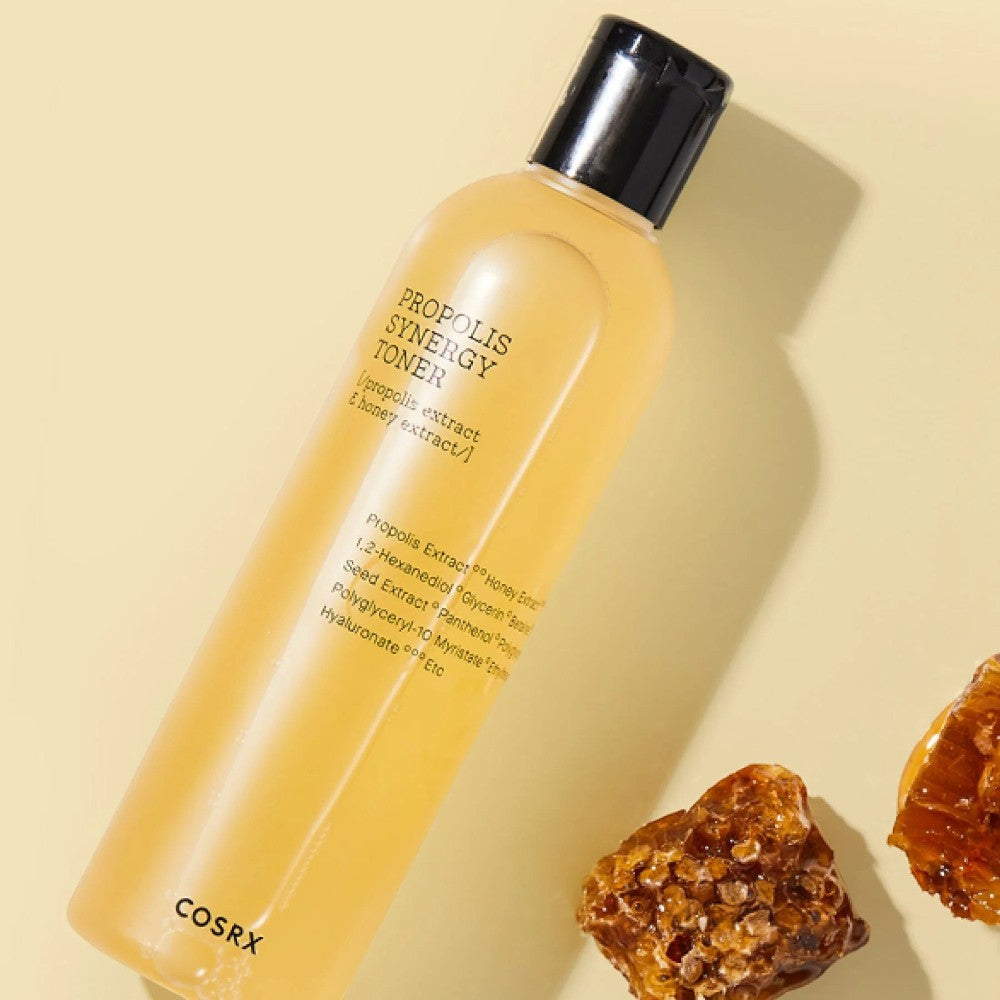 Skin TOGO COSRX Full Fit Propolis Synergy Toner bottle with honey-colored liquid and honeycomb pieces on beige background