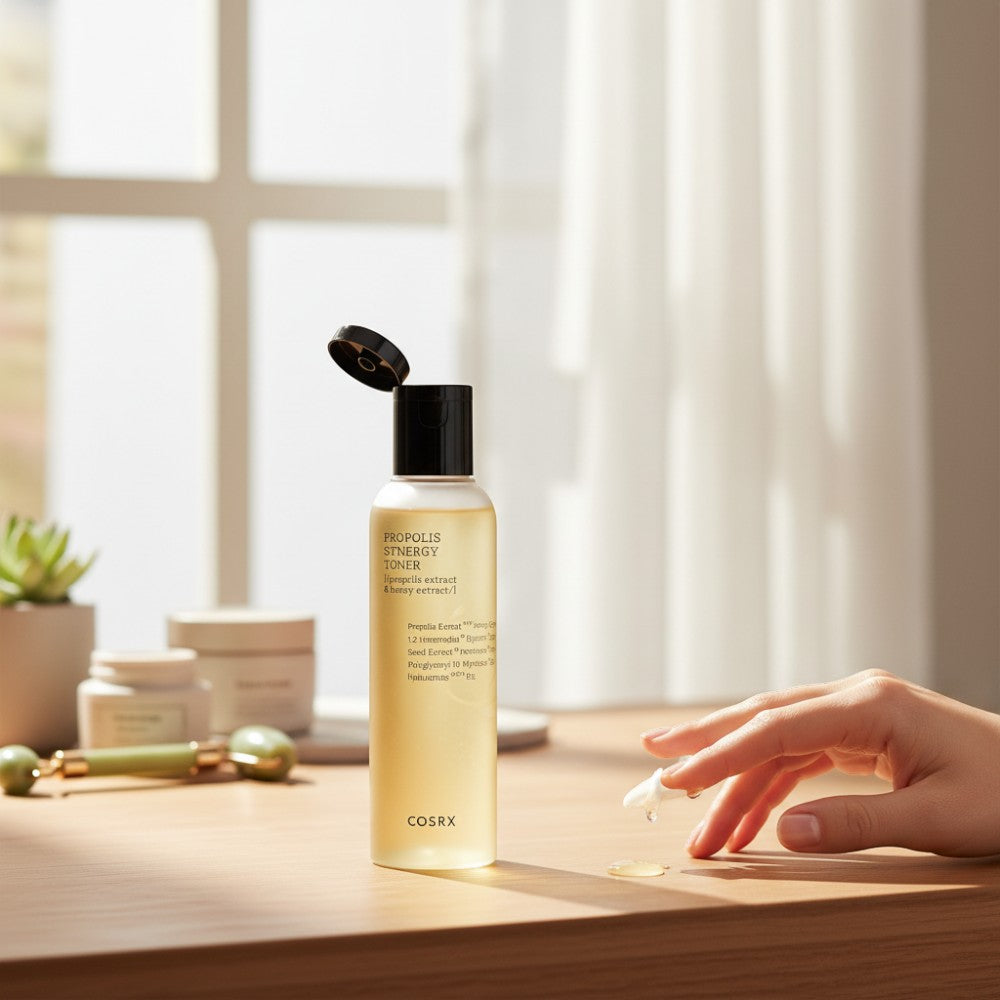 Skin TOGO COSRX Full Fit Propolis Synergy Toner bottle with honey-like texture on a wooden table with a hand