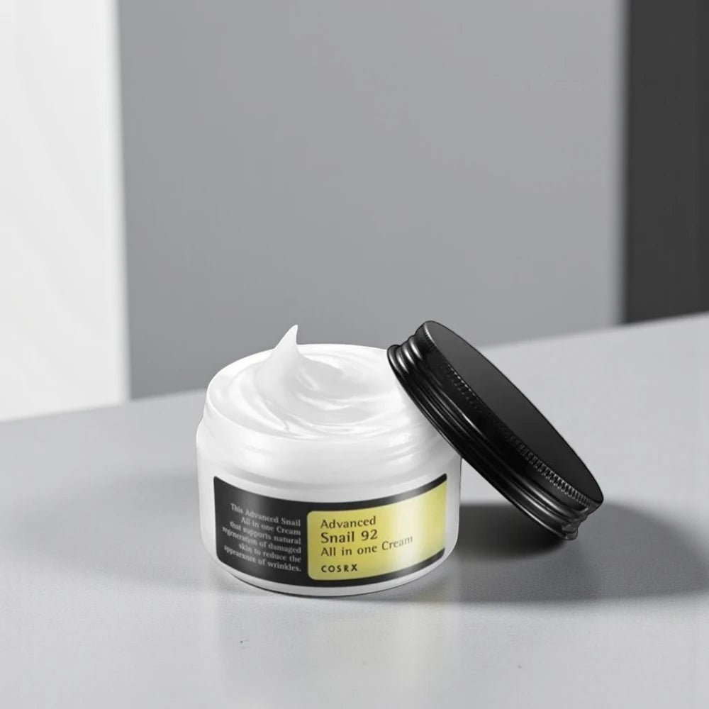 Skin TOGO Cosrx Advanced Snail 92 All In One Cream in an open white jar with a black lid, showing its gel-like texture.
