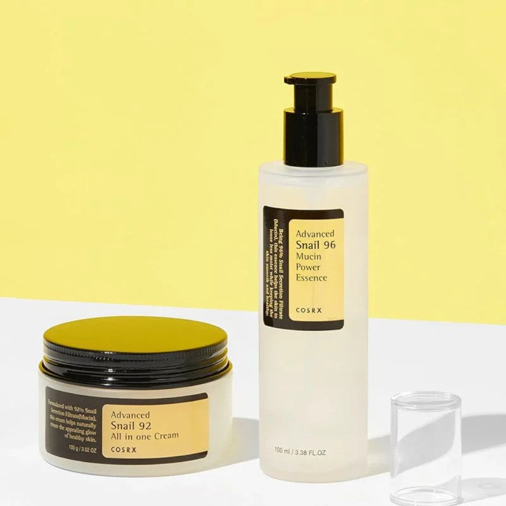 Skin TOGO Cosrx Advanced Snail 96 Mucin Power Essence and 92 All in One Cream set on a yellow and white background.