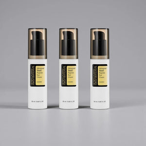 Skin TOGO Cosrx Advanced Snail Peptide Eye Cream in three white pump bottles with black caps on a grey background.