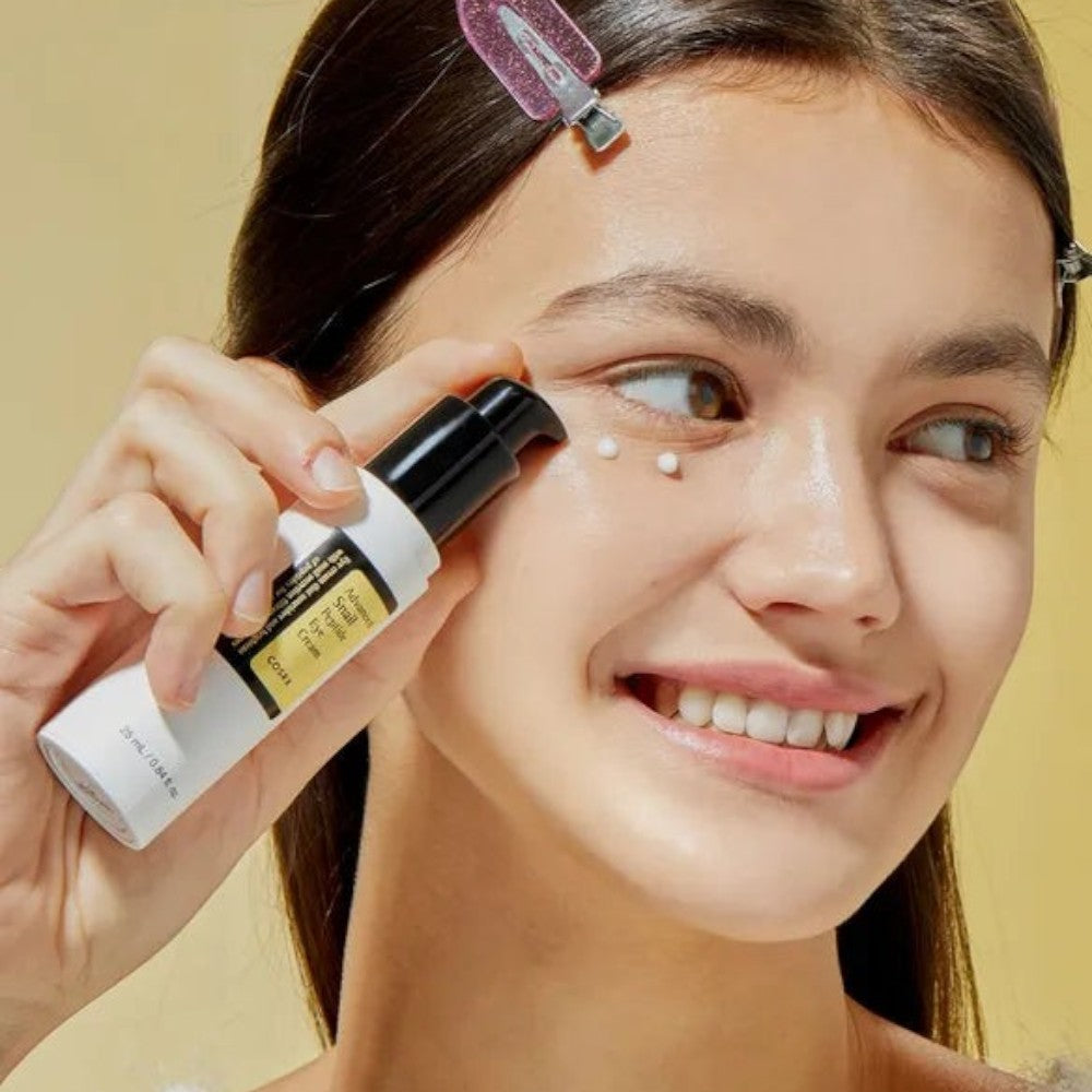 Skin TOGO model applying Cosrx Advanced Snail Peptide Eye Cream to her under-eye area for skin rejuvenation.